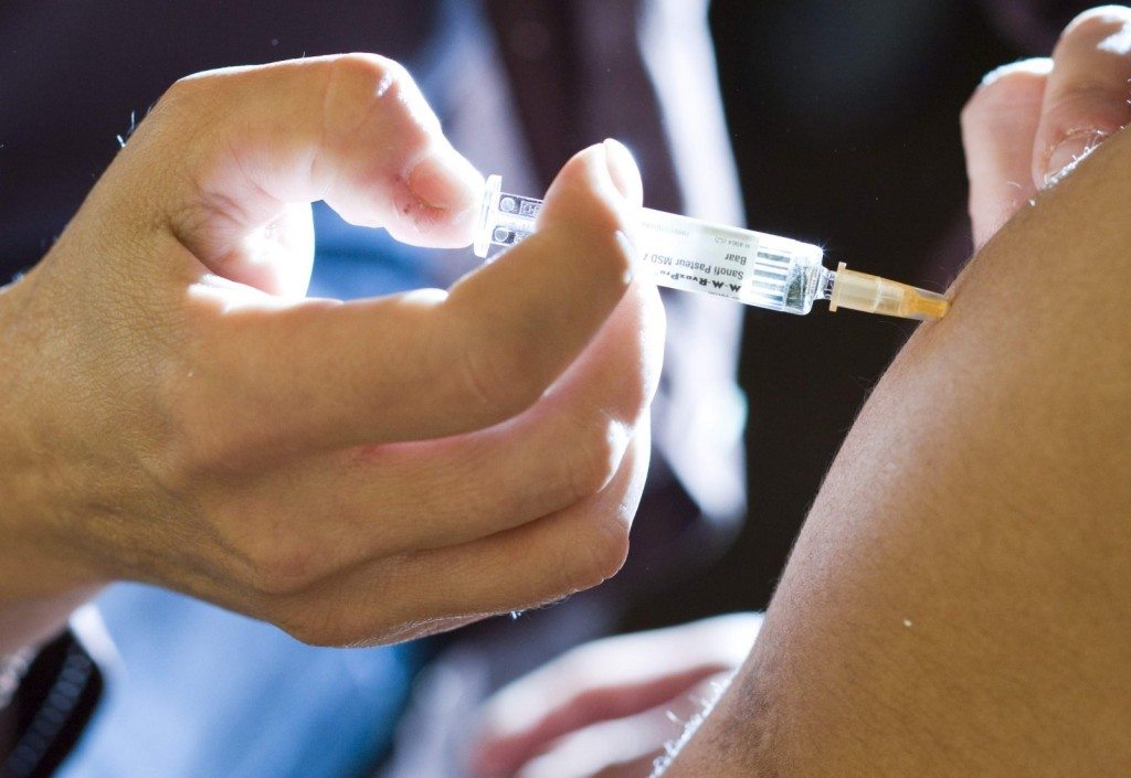 A student receives a measles vaccine injection at the Ecole Polytechnique Federale de Lausanne (EPFL) in Ecublens